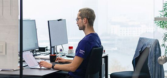 Staff working digitally in his office